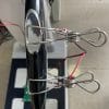 The iBodyinfo RES-MODER BIA calibration fixture being used to validate the performance of a body composition analyzer's handheld electrodes.
