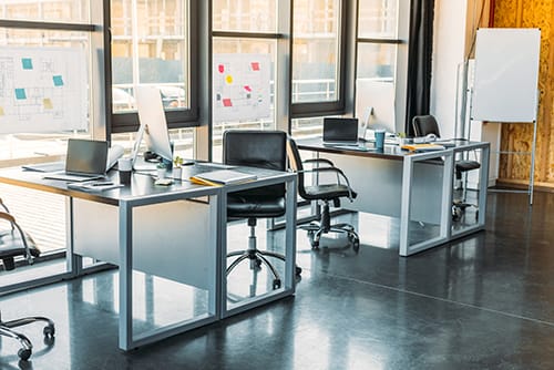 A vibrant space for project planning and discussion, with whiteboards displaying product development blueprints and creative ideas.