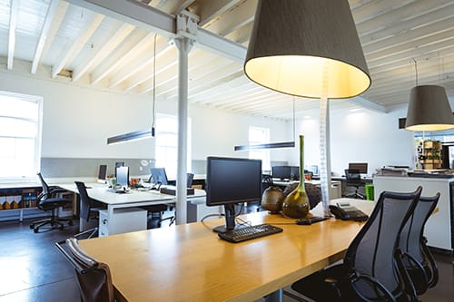 A spacious and bright open-plan office environment designed to encourage team communication and collaboration.